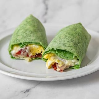 Scrambled eggs with turkey bacon and melted Jack cheese